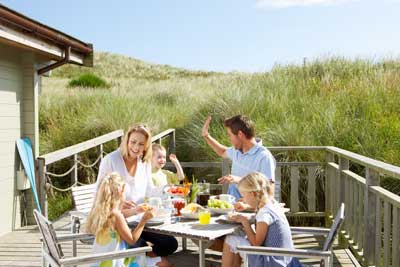 Family eating around outdoor table